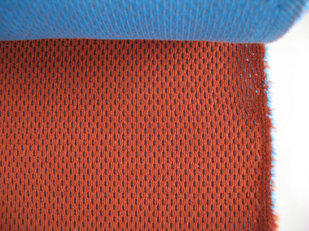 Kvadrat Febrik Plecto 564 rust brown burnt orange blue
