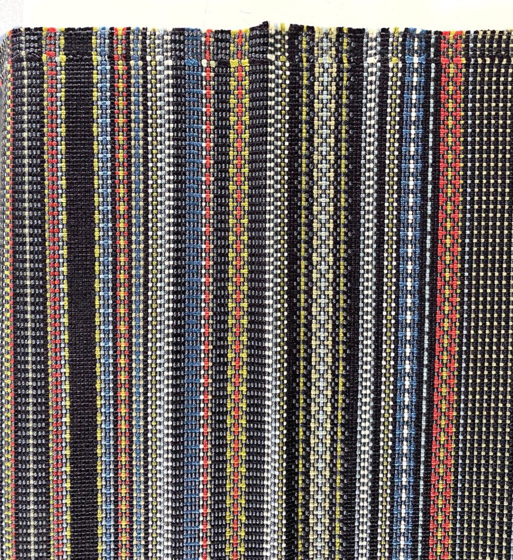 Maharam Point 003 Slate and Khaki – black with coloured accents