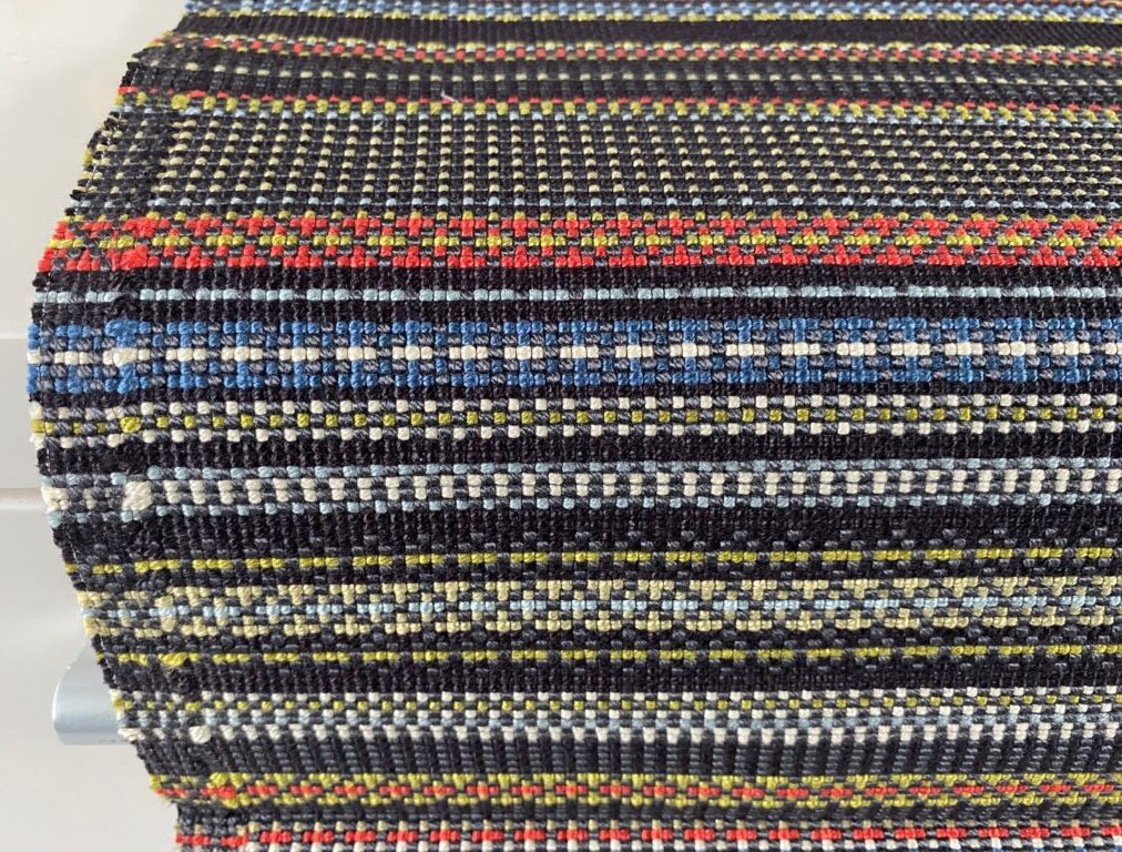 Maharam Point 003 Slate and Khaki – black with coloured accents
