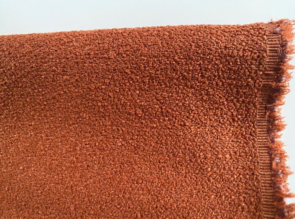Bouclé upholstery burnt orange brown orange