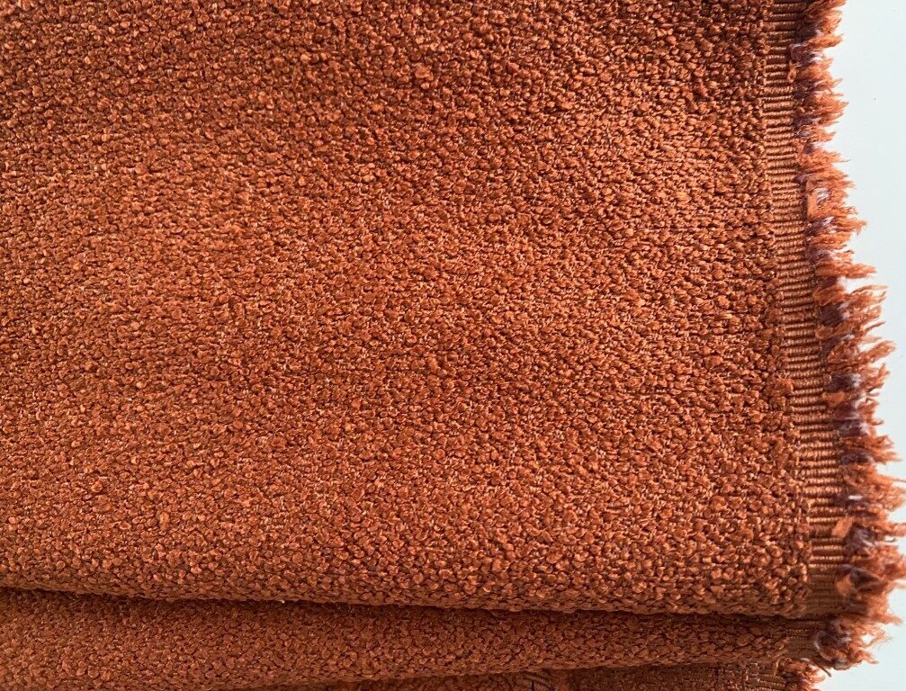 Bouclé upholstery burnt orange brown orange